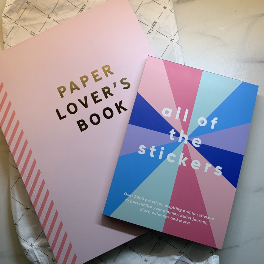 Two Kikki K stationery items, one titled Paper Lover's book and the other titled All of the stickers